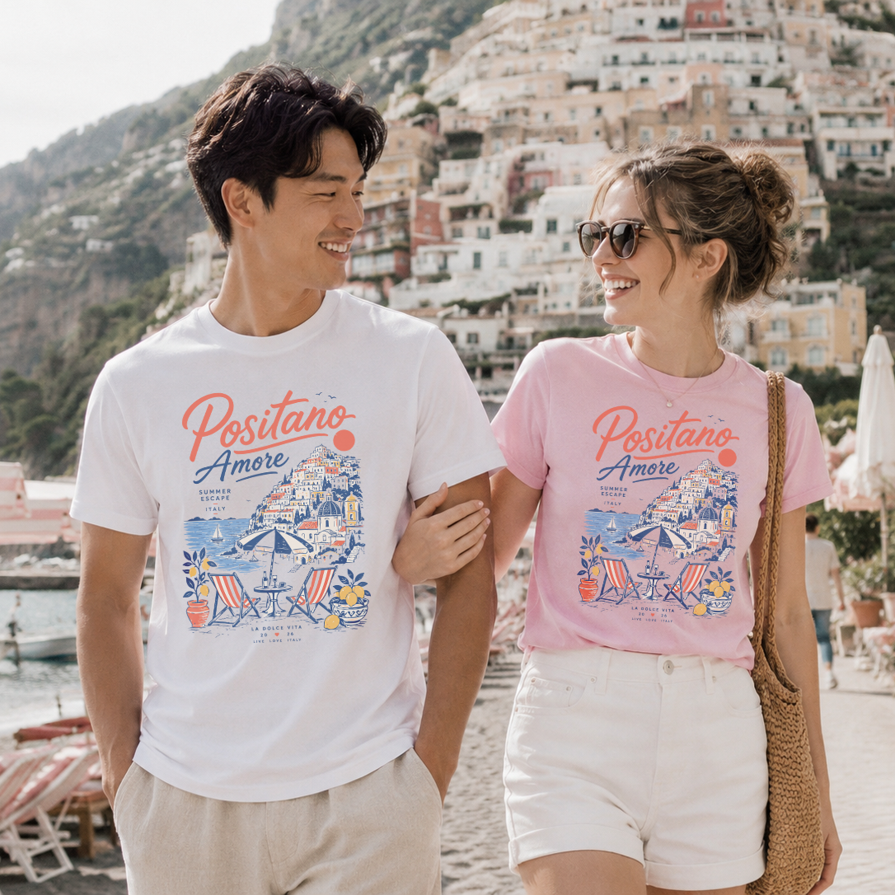 Two people wearing 'Positano Amore' t-shirts with a scenic background.